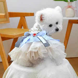 Detail of luxury dog dress with multilayered tulle skirt and heart gemstone bow