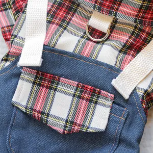 Detail of pet vest showing tartan pocket, denim fabric, and sturdy silver metal D-ring
