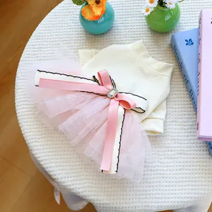 Detail of pink tiered mesh pet skirt with silk bow and sparkling rhinestone centerpiece