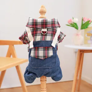 Detail of pet denim overalls and plaid shirt featuring a metal D-ring for leash attachment