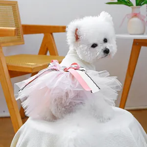 Detail of a sweet pet dress with 3D floral layers and pink ribbon bow on a small dog