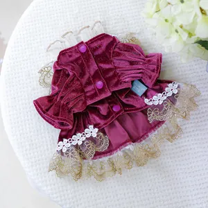 Detailed view of burgundy velvet pet dress with sequins, purple buttons and lace hem