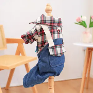 Detail of plaid shirt and denim overalls for pets displayed on a wooden pet mannequin