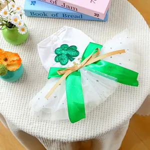 Detail of pet wedding dress with green clover embroidery and large silk bow