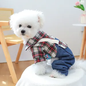 Detail of red plaid shirt and navy denim overalls pet suit on a small dog model