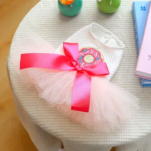 Close-up of pet princess dress with pink mesh tutu and donut embroidery detail
