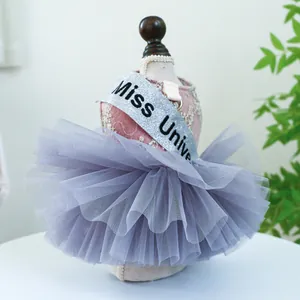 Détail de robe rose en dentelle pour animal avec écharpe Miss Universe et tutu gris