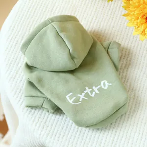 Detail of sage green pet hoodie with soft cotton fleece texture and white Extra print