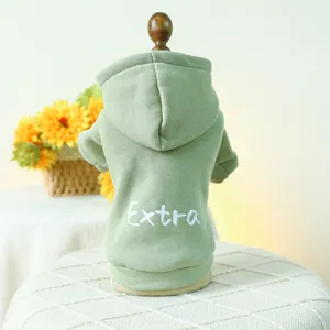 Detail of green hooded pet sweatshirt featuring white Extra lettering on soft cotton fabric
