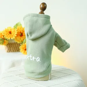 Close-up of green pet hoodie with extra print, ribbed hem and soft cotton texture