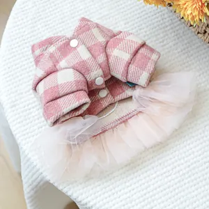 Detailansicht eines rosa karierten Haustierkleides mit weißen Knöpfen und Tüll-Spitze