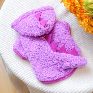 Detail of purple plush dinosaur pet hoodie with dorsal fins and metal D-ring attachment