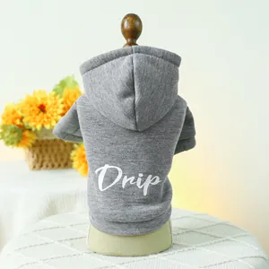 Macro detail of grey cotton pet hoodie featuring white Drip print on wooden mannequin
