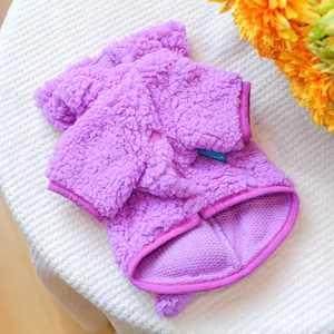Detail of purple sherpa fleece pet jacket featuring textured pile and brand label