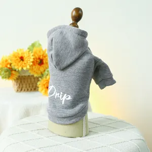Detail of grey pet hoodie with white Drip print on a wooden model with sunflowers