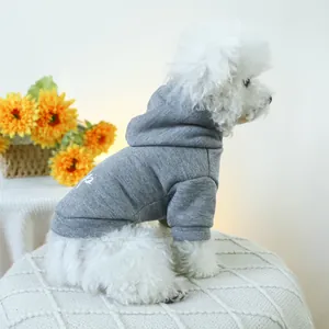 Detail of grey pet hoodie with hood and white artistic lettering on a Bichon Frise