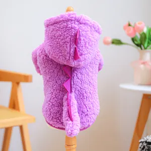 Detail of purple dinosaur pet hoodie featuring pink plush fins on warm fleece fabric