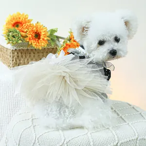 Detalle del vestido para perro con lunares y volantes de encaje y collar de perlas