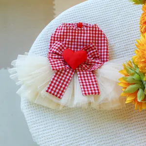 Detail of pet dress with red checkered pattern, large bow, and 3D heart on tulle skirt