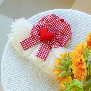 Detail of red gingham pet dress with 3D heart patch and layered white mesh tutu
