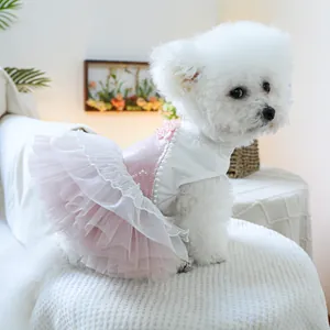 Detail of pet princess dress featuring pink sequins, lace layers, and pearl trim on a dog