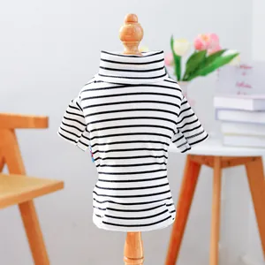 Close-up of black and white striped pet sweater with high neck and ribbed knit texture