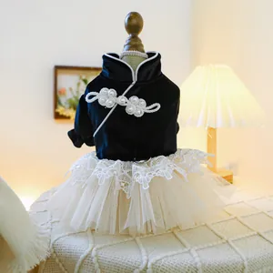 Close-up of black velvet pet dress with pearl buttons and metal D-ring for leash