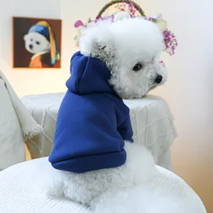 Detail shot of a dark blue pet hoodie on a white dog showing soft cotton fleece texture