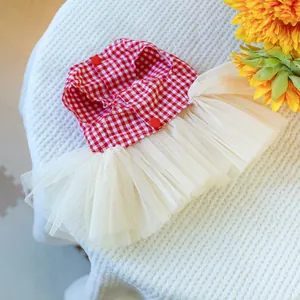 Close-up of pet dress featuring red gingham pattern and layered cream tulle skirt