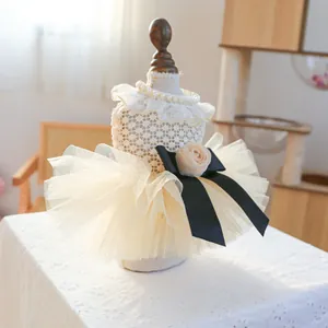 Elegant cream pet wedding dress with lace bodice, mesh tutu skirt and black bow detail