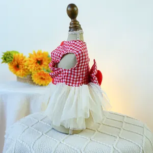Detail of red and white plaid dog dress with layered tulle skirt and decorative buttons