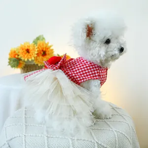 Detail of red and white checkered pet dress with mesh tutu skirt and bow for small dogs