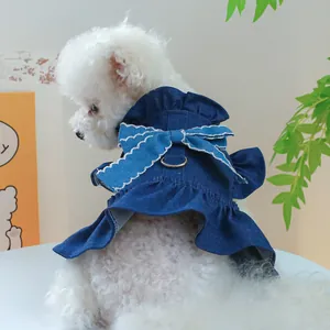 Detail view of denim pet dress with large white-edged bow and metal D-ring for small dogs