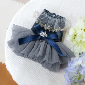 Detailed view of luxury pet dress featuring navy velvet bow and crown rhinestone buckle