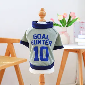 Detail of green waffle dog shirt with Goal Hunter 10 print on wood hanger