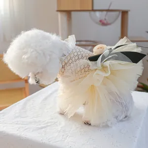 Detail of pet princess dress with delicate lace, yellow mesh bow and 3D rose decoration