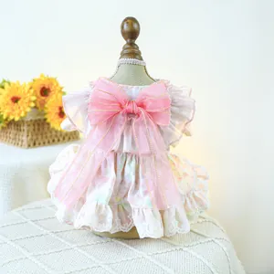Detail of pet floral dress with oversized pink mesh bow and white lace trim edge