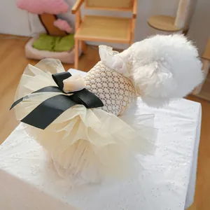 Detail of elegant dog wedding dress with black bow and layered lace tutu skirt