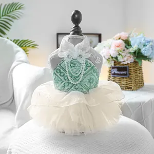 Detail of pet wedding dress with green sequins, lace collar and pearl chain accents