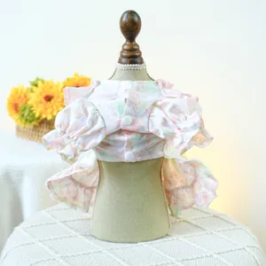 Detail of floral pet dress with puff sleeves and lace hem on a mannequin