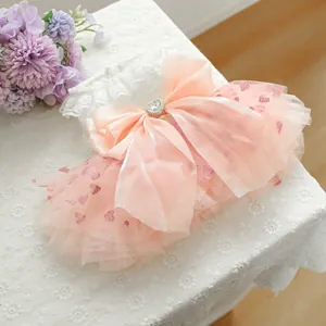 Pink pet princess dress with sequined hearts, mesh layers, and a large satin bow accent