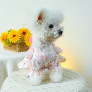 Detailed view of pink floral pet dress with bubble sleeves and ruffles on a dog