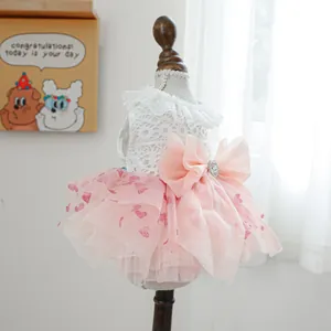 Close-up of pet princess dress with lace bodice, pink tutu skirt, and rhinestone bow