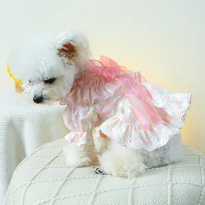 Detail of pink floral pet dress with large mesh bow and delicate white lace trim