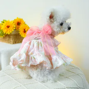 Detail of pink floral dog dress with large bow, lace trim and integrated metal D-ring