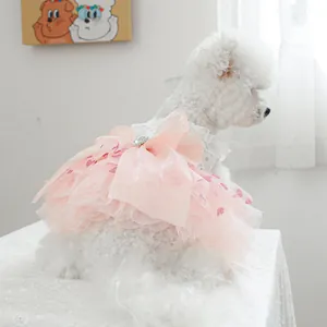 Detail of pink mesh pet dress featuring large bow and pearl rhinestone buckle