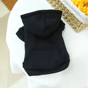 Detail of a black pet hoodie with a hood and pocket on white honeycomb texture fabric