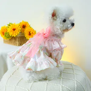 Detail of pink floral pet dress featuring a large mesh bow and delicate lace ruffles