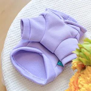Detail of lavender pet hoodie featuring soft fleece fabric and ribbed edge on white knit