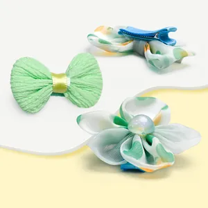 Cute pet hair clips set featuring green floral bows and a fabric flower for dogs